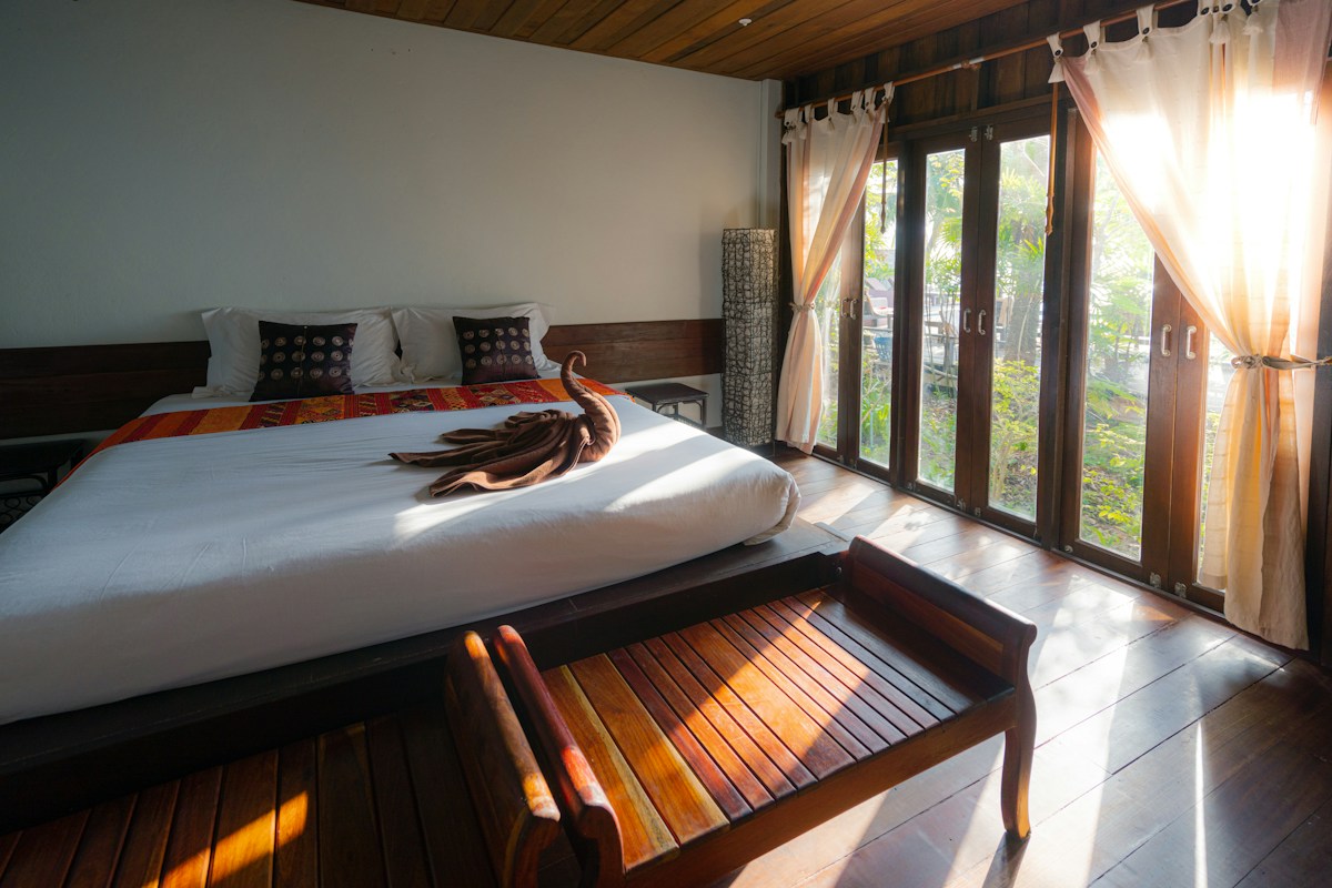 A spacious residence with a restful bedroom and warm coastal light